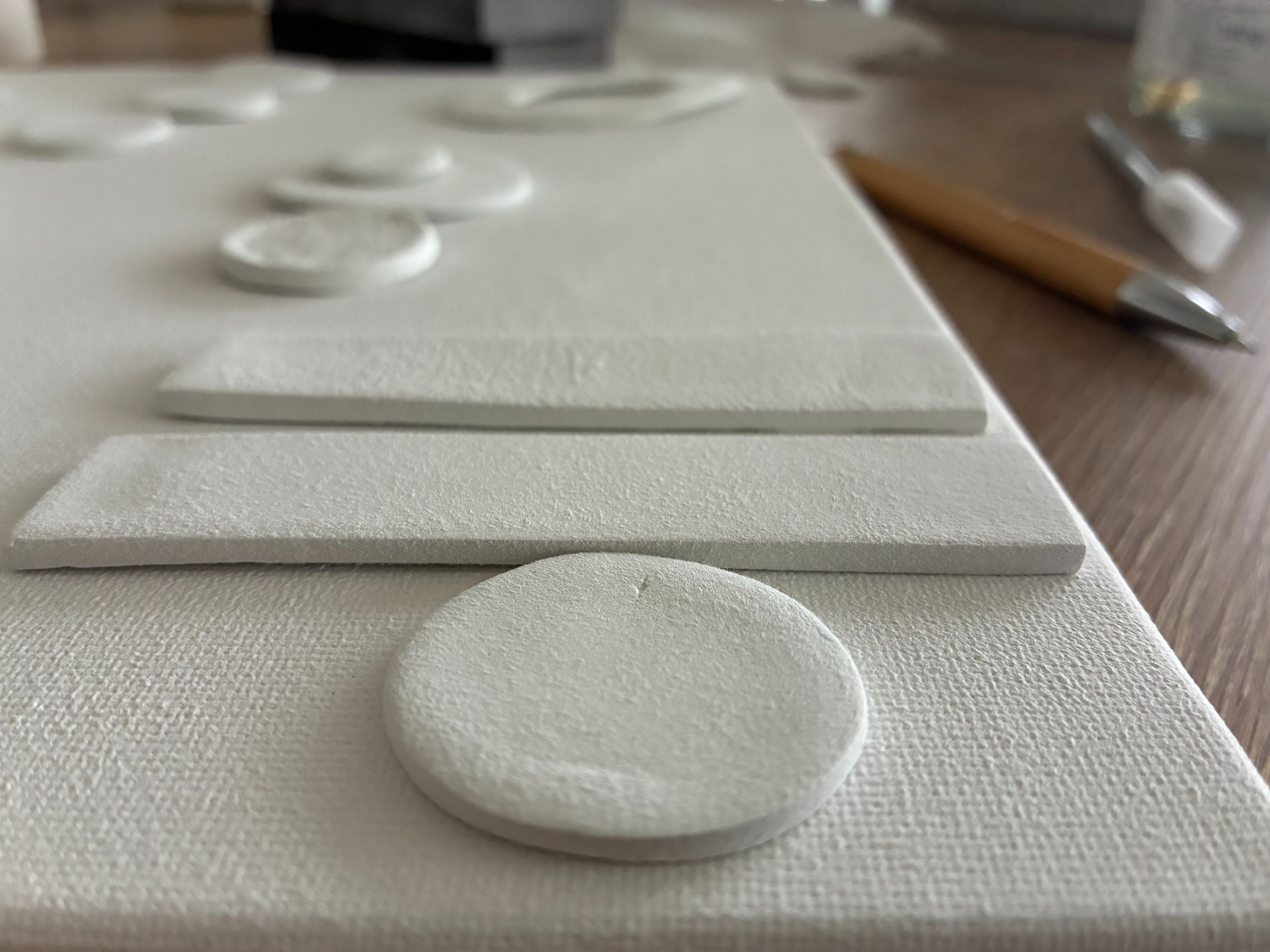 Ivonne Coccaglio art studio process — mixed media and clay on canvas